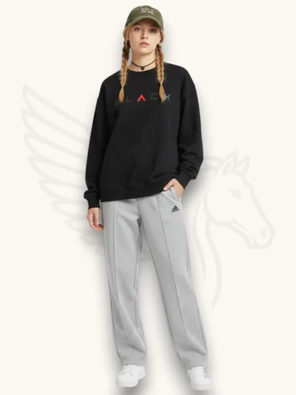 Black sweatshirt and light gray trouser tracksuit set on a female model, full outfit