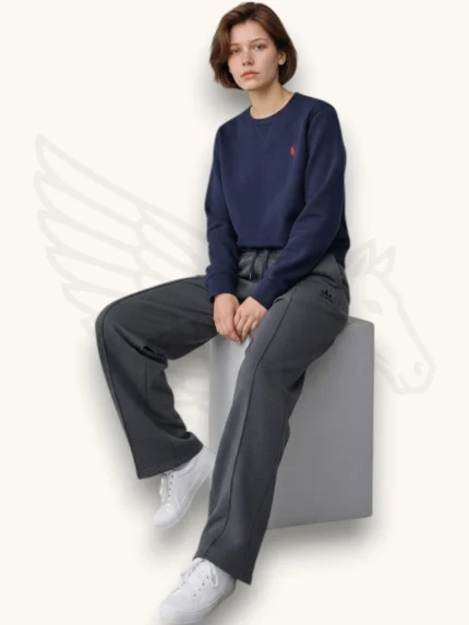 Navy blue sweatshirt and charcoal gray trouser tracksuit set on a female model, seated