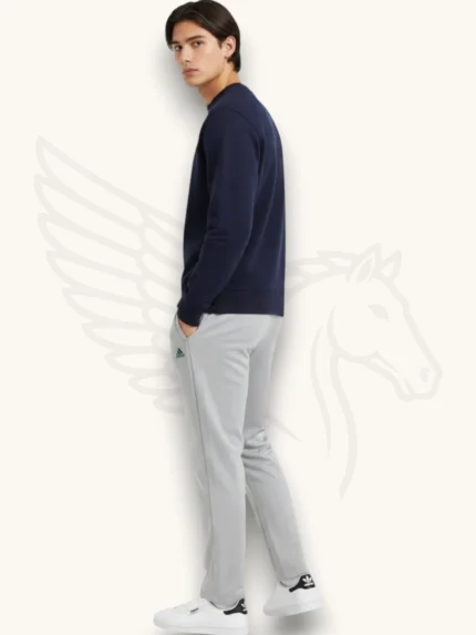 Navy blue sweatshirt and light gray trouser tracksuit set on a male model, side view